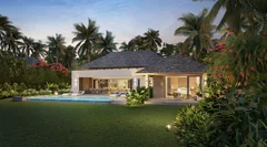 Villa Fairway La Réserve avec intérieurs éclairés, piscine et jardin tropical au crépuscule